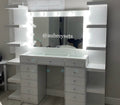 White vanity with mirror and lights in a room setting